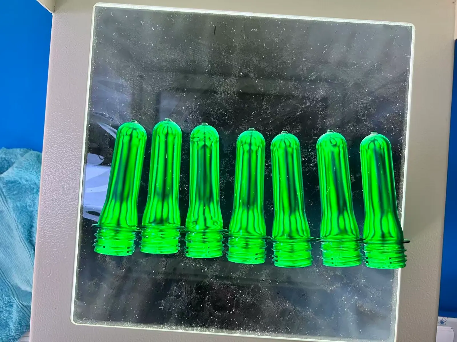 Real PET preforms under polarized light inspection for a beverage bottle project